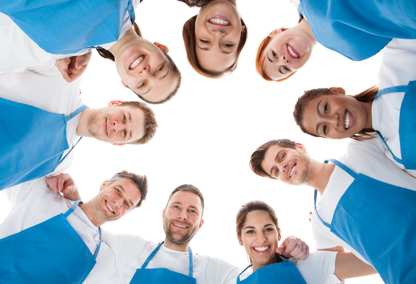 Large group of cleaners standing in circle. Isolated on white